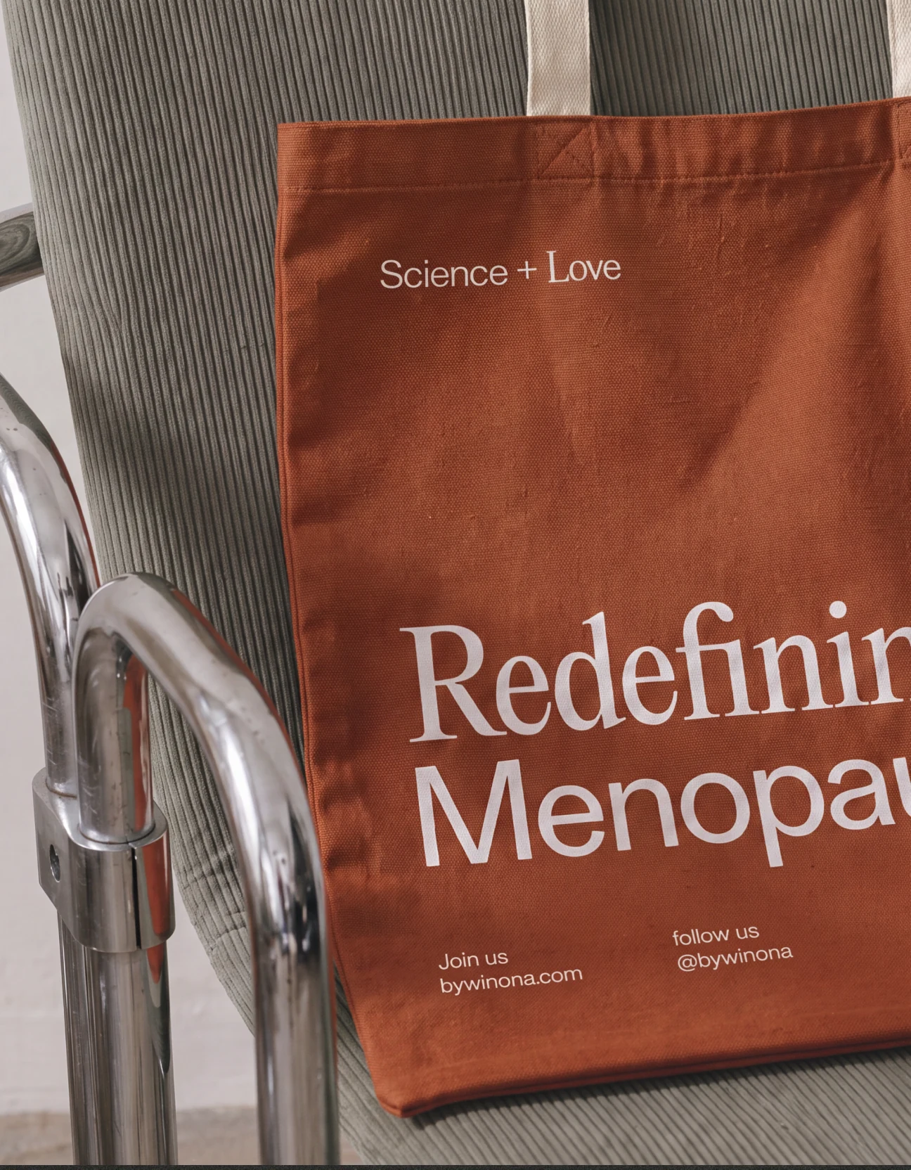 Winona Redefining Menopause tote bag on a chair.