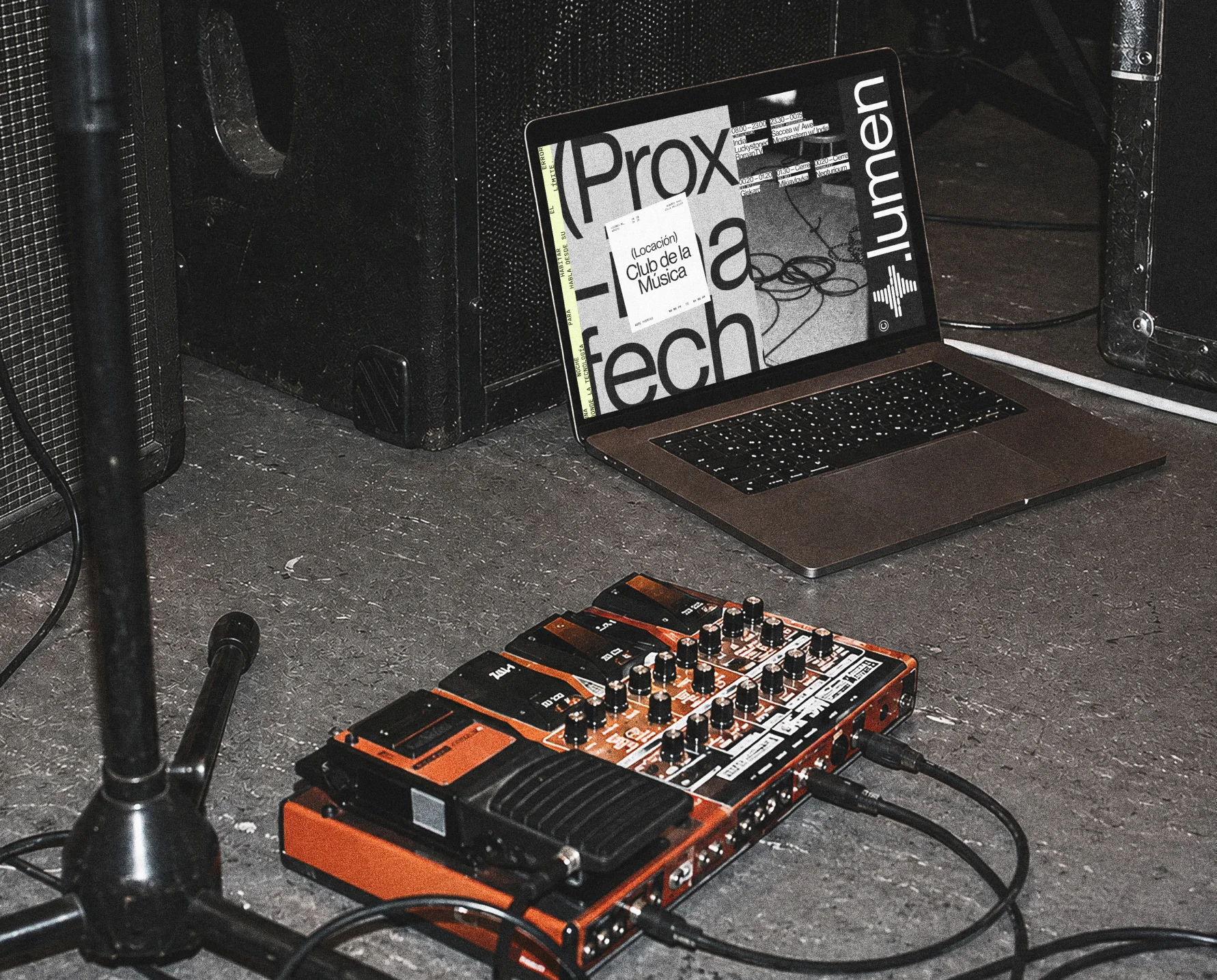 Lumen visuals shown on a laptop beside event equipment.
